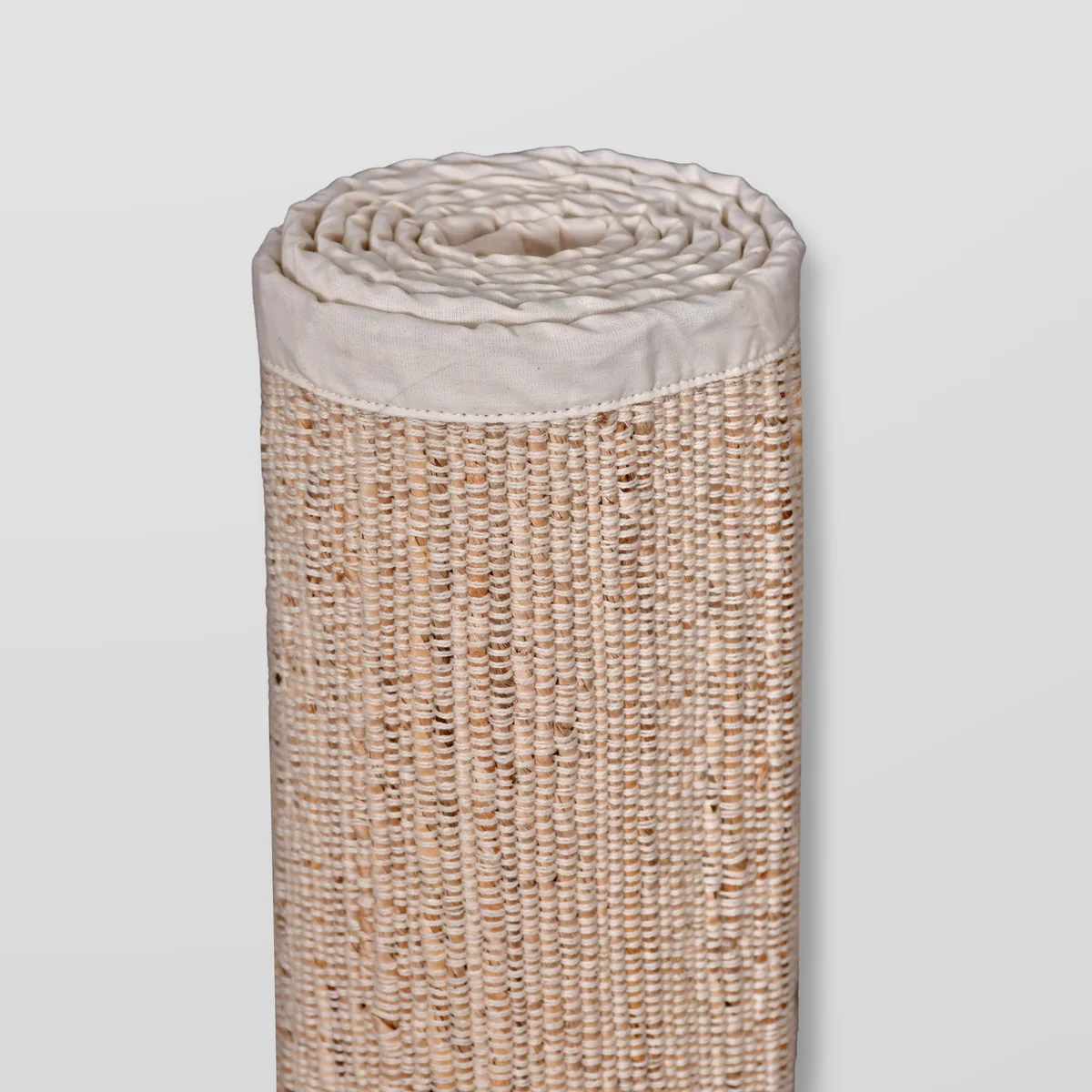 Banana fibre mat close-up, showing the undyed bark strips bound with cotton