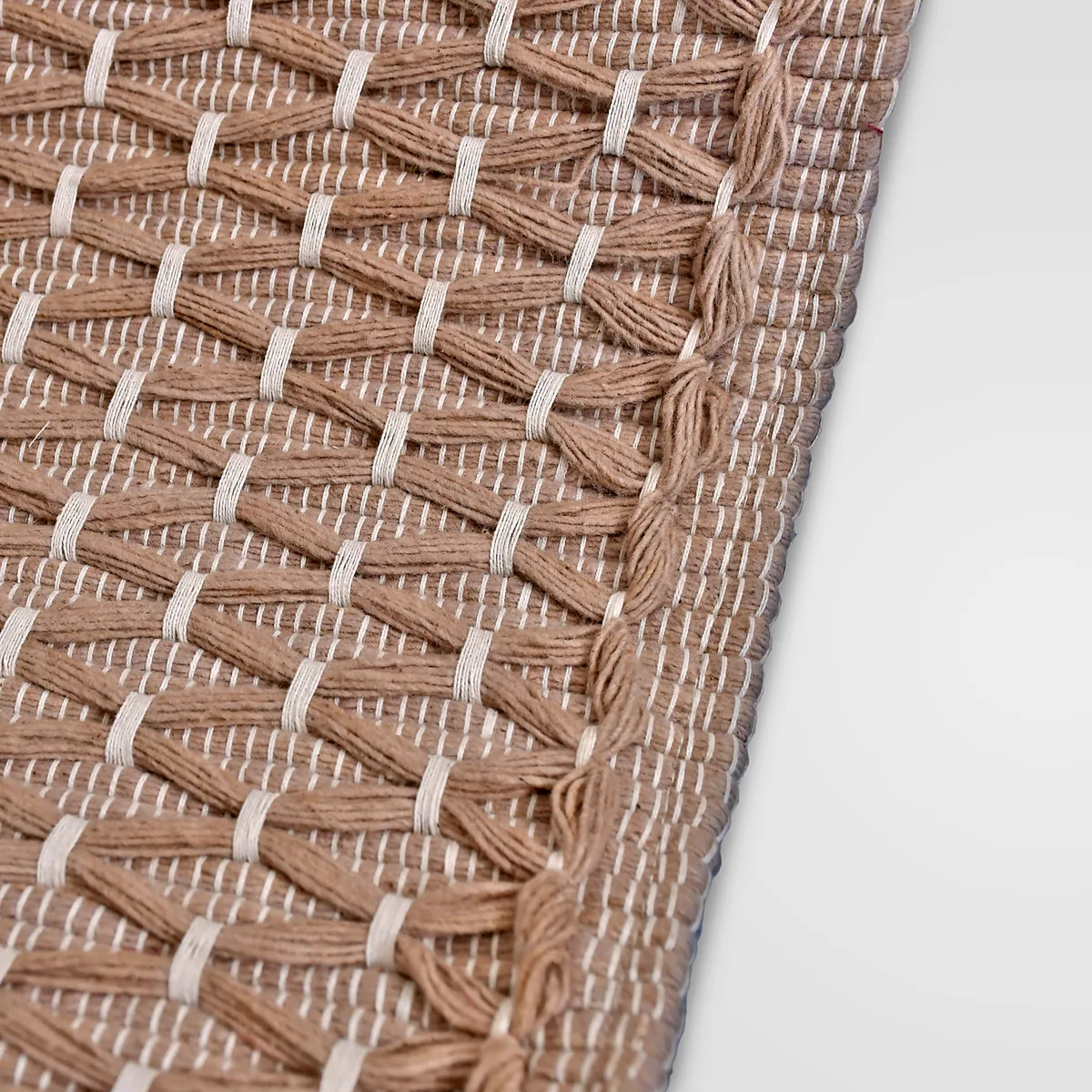 Close-up of the Diamond Clay mat's raised diamond lattice in alkanet-dyed cotton