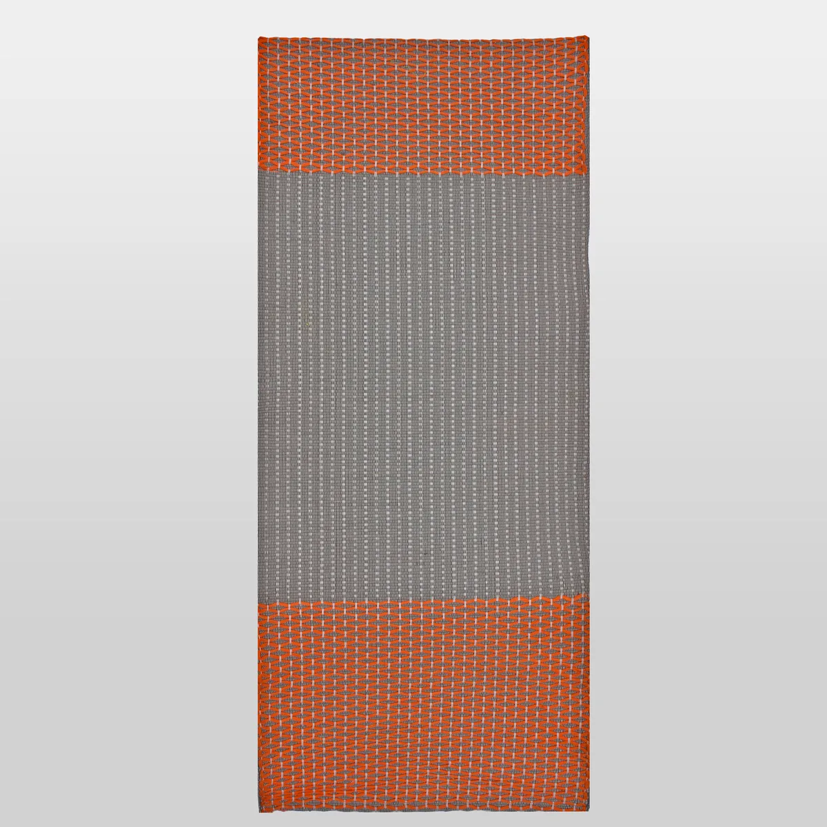 Diamond Orange cotton mat laid flat, a plant-dyed orange diamond lattice on a grey ground