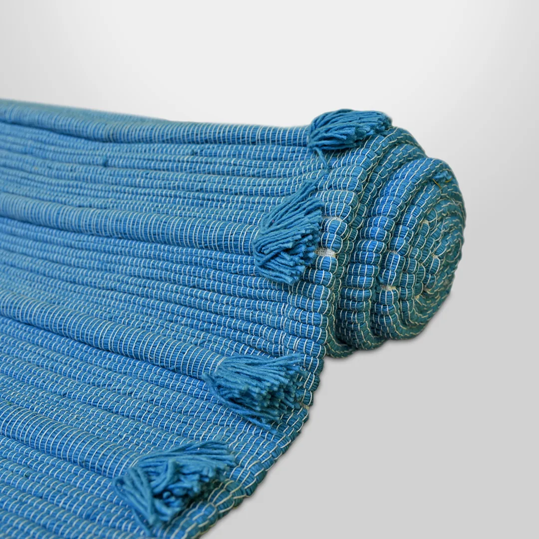Detail of the Indico mat's ribbed indigo weave and hand-knotted tassels