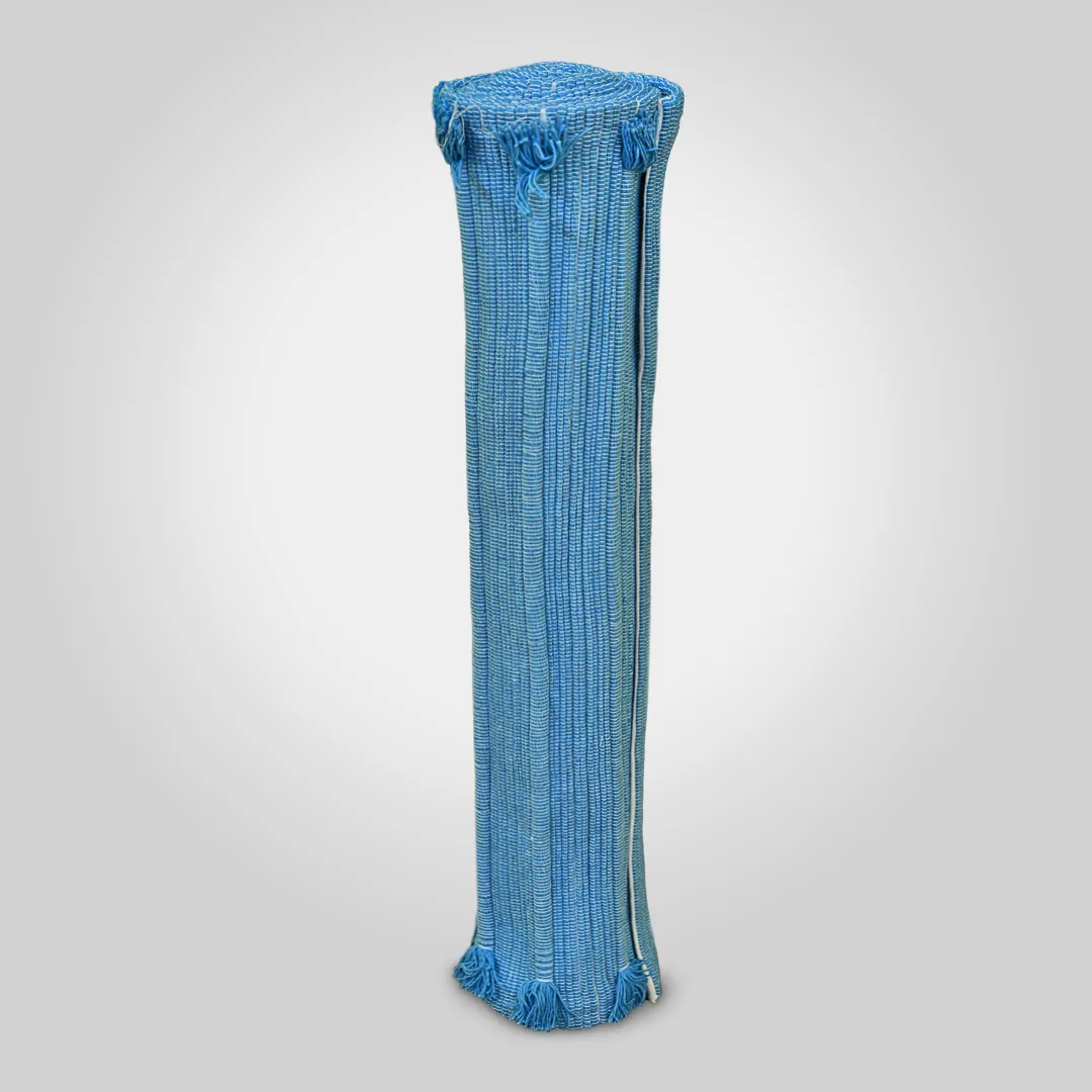 Indico yoga mat rolled and standing, showing the indigo ribbed weave and tassels