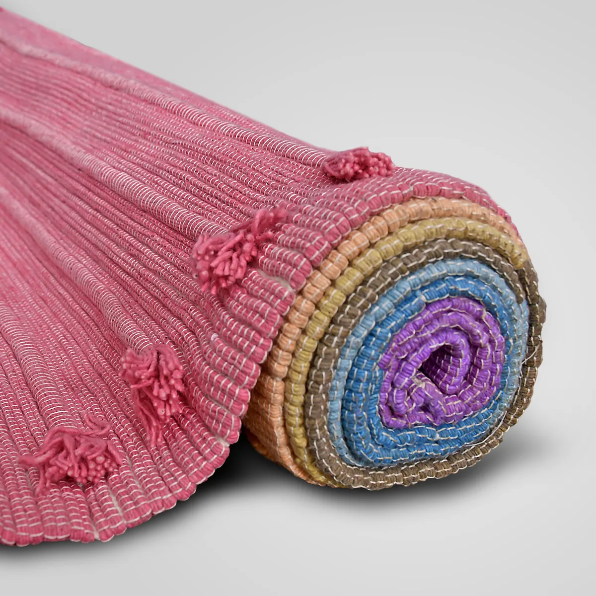 Prana Shakti mat half unrolled, showing the chakra bands at the core